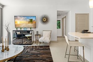 A living room with a television, a chair, and a table.